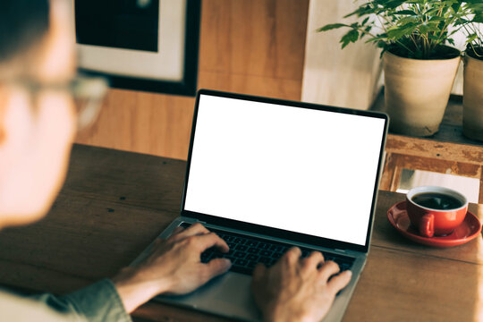computer screen blank mockup.work using laptop with white background for advertising,contact business search information on desk at coffee shop.marketing and creative design