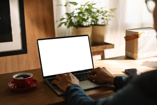 computer screen blank mockup.work using laptop with white background for advertising,contact business search information on desk at coffee shop.marketing and creative design