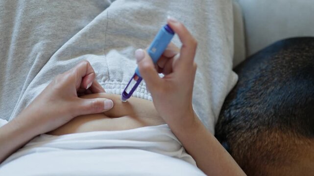 Woman injecting semaglutide into abdomen with pen.medicine treatment for obesity and diabetes.