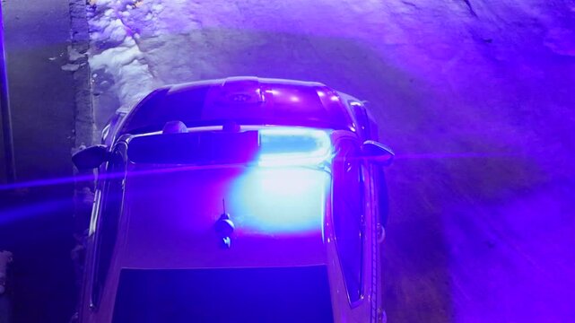 Top View Flashing Blue Lights Police Vehicle at Night
