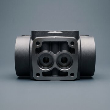Ductile Iron Hydraulic Valve Manifold Block on Dark Background