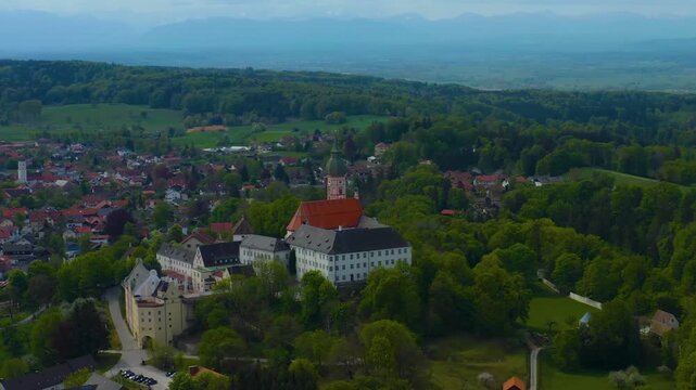 Aerial view above the city and monastery and brewery Andechs beside the Ammersee lake, on a cloudy noon in Spring in Germany