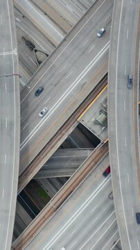 AERIAL: Spectacular Overhead Shot of Judge Pregerson Interchange showing multiple Roads, Bridges, Highway with little car traffic in Los Angeles, California on Beautiful Sunny Day