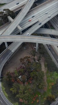 AERIAL: Spectacular Fly over Judge Pregerson Interchange showing multiple Roads, Bridges, Highway with little car traffic in Los Angeles, California on Beautiful Sunny Day
