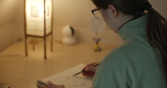 Girl Draw Pictures With Pencil on Desk Table in Bedroom at Home. 4K 10-bit