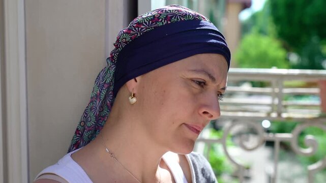 Thoughtful woman during health recovery looking into distance, contemplative portrait expressing resilience, strength, reflection and determination