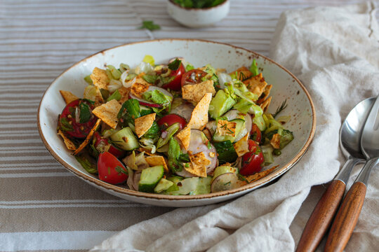 Fresh fattoush salad healthy vegetables pita summer Lebanese Mediterranean Middle East linen table