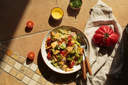 Fattoush summer salad terracota tile bright sunlight Mediterranean Middle east Lebanese