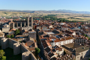 Obraz premium Wide aerial view of Avila historic quarter with red rooftops and Castilian plains