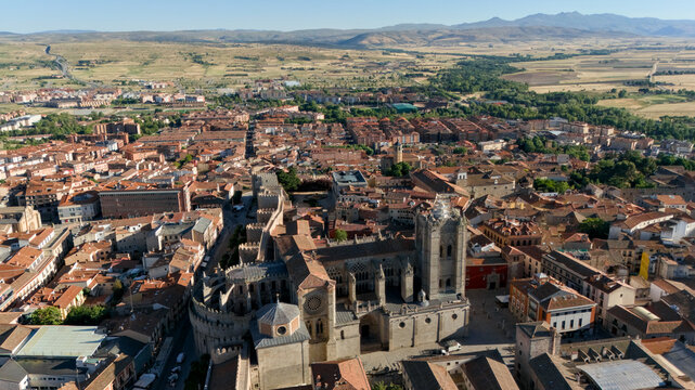 Cathedral apse integrated into medieval city walls with panoramic Avila cityscape