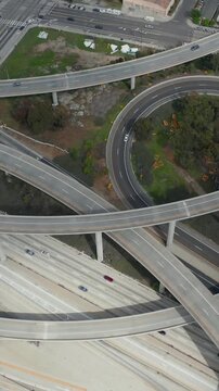 AERIAL: Slowly Circling over Judge Pregerson Huge Interchange showing multiple Roads, Bridges, Highway with little car traffic in Los Angeles, California on Beautiful Sunny Day 