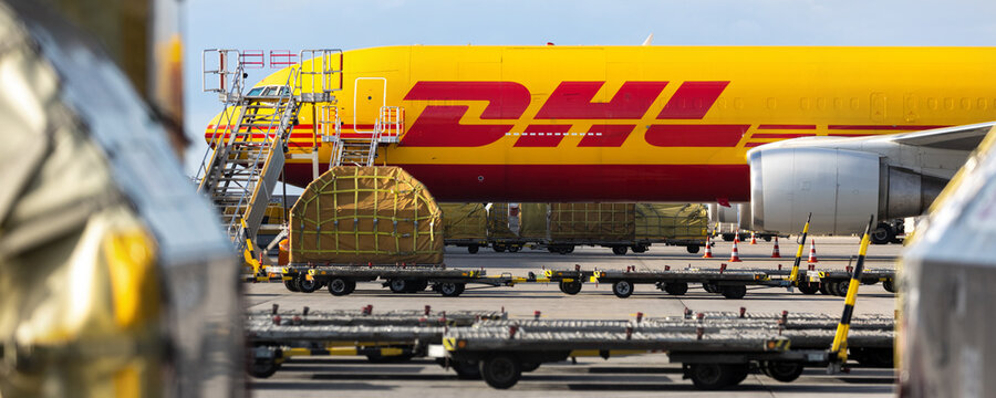 Schkeuditz, Germany - 23th August, 2025 - Many big cargo planes parked on Leipzig Halle airport terminal tarmac apron for loading, service maintenance. DHL air mail express fast logistic hub terminal