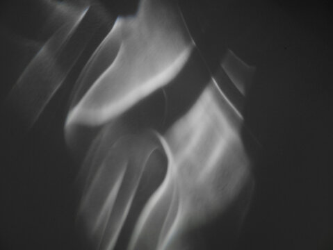 Soft curves of caustic rays. Abstract caustic light patterns created by refraction and reflection on a transparent surface. Can be used as overlay elements for design projects. 