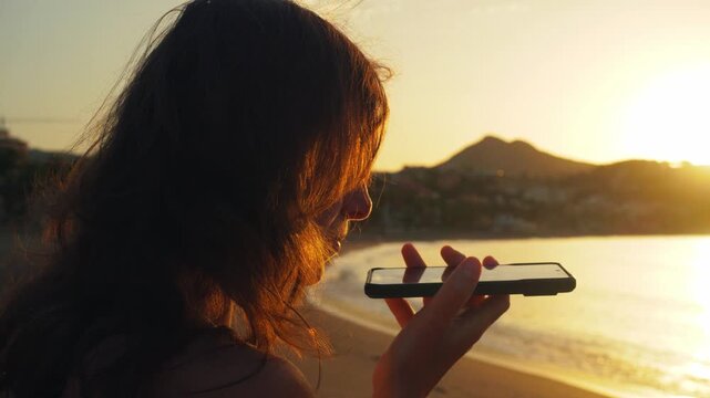 Woman embracing serene connection on a peaceful beach at golden hour, exuding calmness and personal growth, perfect for travel and wellness campaigns.