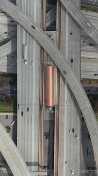 AERIAL: Spectacular Overhead follow Shot of Judge Pregerson Interchange showing multiple Roads, Bridges, Highway with little car traffic in Los Angeles, California on Beautiful Sunny Day