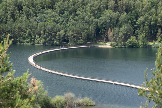 View of the floating bridge and tourist attraction "Cycle between the Mine Terrils" in the "Hoge Kempen" National Park, at Terhills, near Dilsen-Stokkem in Limburg, Belgium. Copy space above.
