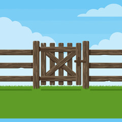 A rustic wooden fence stands in a bright green field © kaka