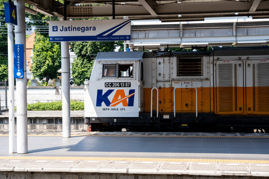 Jakarta, Indonesia - May 28, 2026: A close-up of a KAI CC206 diesel-electric locomotive hauling a long-distance passenger train through Jatinegara Station.