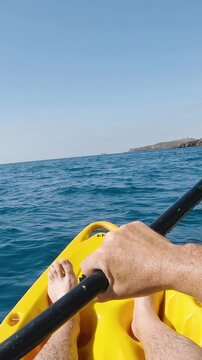 First person view kayaking in the mediterranean sea on a sunny summer day. Concept about summer, lifestyle,wanderlust travel and nature - vertical video for story and reels