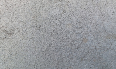 Fototapeta premium Grungy concrete wall texture with fine cracks, weathered gray cement surface background, industrial stone plaster material for architectural design