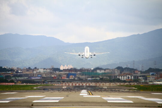 A commercial passenger jet takes off from the runway.