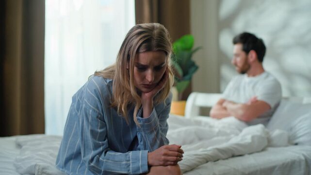 Offended Caucasian couple stressed separating on bed. Family intimacy problem sad upset woman wife with frustrated man husband ignoring separate in bedroom relationship psychological love trouble