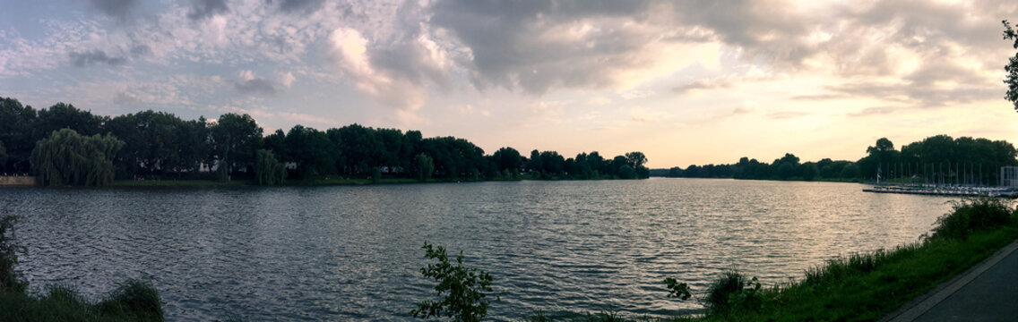 Panoramic lake view at sunset with dramatic sky and marina