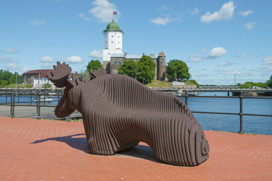 VYBORG, RUSSIA - JUNE 19, 2026: The "Elk" bench against the background of the ancient Vyborg castle on the sunny June day