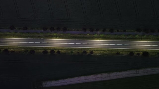 Aerial Night Footage of Car Driving on Dark Rural Road &ndash; 4K ProRes