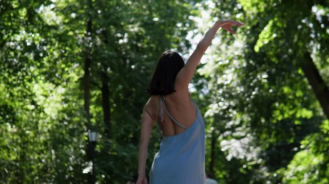 Narrative sequence showing woman progressing from pause to closing walk: starts standing on shaded path, then raises arm and moves forward, and by near-end