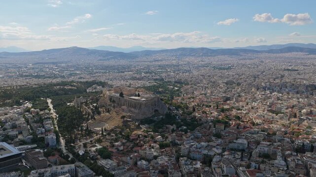 Athens cityscape flying on the Acropolis of Athens, Parthenon and Odeon of Herodes Atticus, with ancient ruins and historic landmarks in Greece