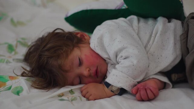 Close up of sleeping toddler resting peacefully on bed at home, highlighting comfort, childhood wellbeing, security and restorative sleep