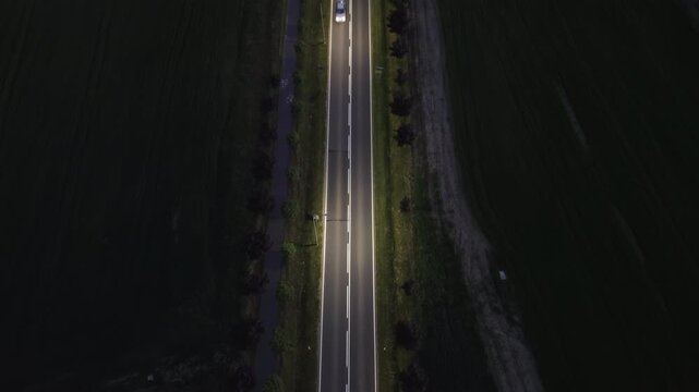 Aerial Night Footage of Car Driving on Dark Rural Road &ndash; 4K ProRes
