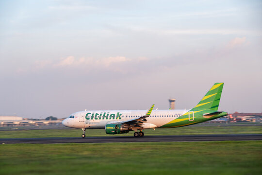 Jakarta, Indonesia - May 28, 2026: Citilink Airbus A320 taxiing on the runway at Soekarno-Hatta International Airport during the late afternoon.