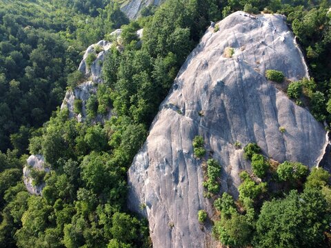 Aerial view of Sasso di Sant'Andrea, a prominent sandstone geological feature surrounded by dense forest. Zocca, Modena, Emilia-Romagna, Italy