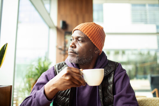 Mature man drinking coffee in cafe