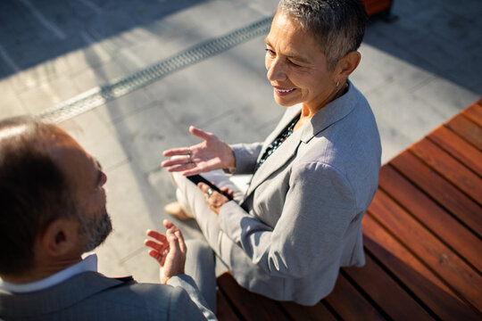Business colleagues discussing strategy on outdoor bench