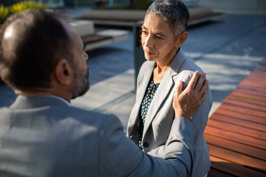 Business colleagues offering support in outdoor office courtyard