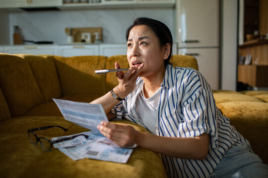 Worried woman calling about bills at home