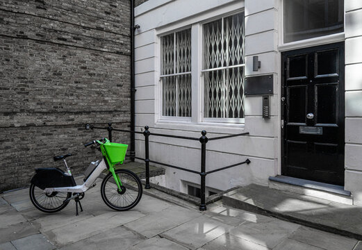 Rental bicycle in front of a brick wall in London.