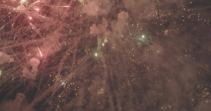 Golden fireworks exploding in night sky during celebration