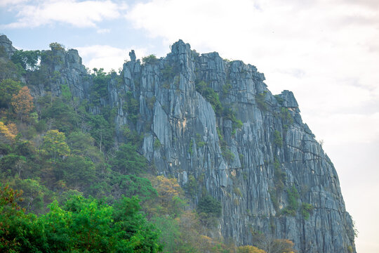 The close-up natural backdrop of the towering Khao Nor Kaeo mountain in Nakhon Sawan, Thailand, offers stunning views during adventurous travel.