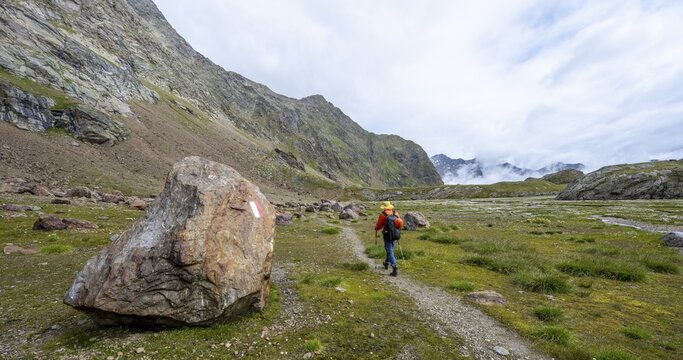 Mountaineers on a hiking trail, high mountain landscape at the Obere Senner Egete, Seven Lakes Hike, Stubai Alps, near Ridnaun, South Tyrol, Italy
