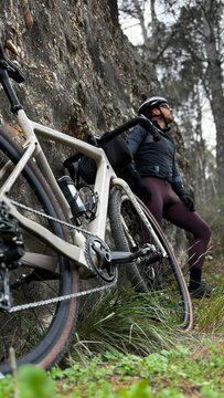 Cyclist pausing on gravel trail exploring nature