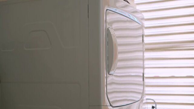 Home clothes dryer running. Uncompressed 24 bit high quality sound. Professional audio recording of household appliance in action. Laundry routine, modern home technology and domestic life concept.