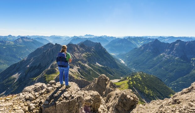 Hiker with views of mountains and Alps, view from the Hochvogel, left Kleiner Ro&szlig;zahn, Allg&auml;u, Allg&auml;uer Hochalpen, Bavaria, Germany