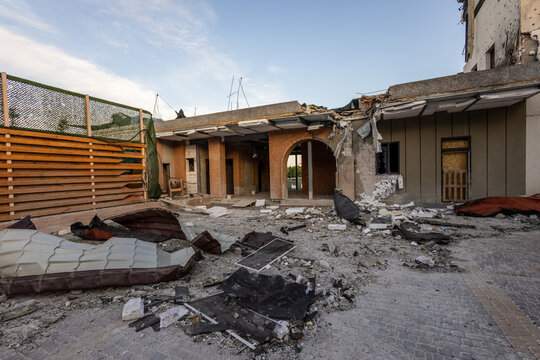Bila Tserkva, Kyiv region, Ukraine - 09.06.2025: Wide angle view of damaged modern building complex with collapsed concrete roof shattered window shrapnel holes and metal debris after explosion