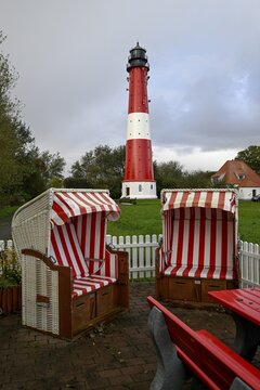 Beach chairs in front of the lighthouse from 1906, Pellworm island, Schleswig-Holstein Wadden Sea National Park, North Frisia, Germany