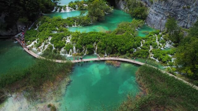 Stunning aerial view of the Plitvice Lakes National Park, Croatia, showcasing turquoise water, lush greenery, and wooden walkways
