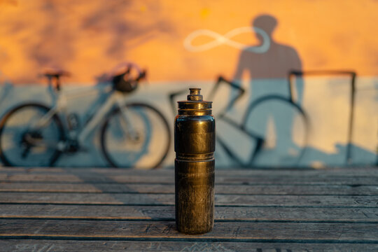 Bicycle water bottle standing on wooden surface